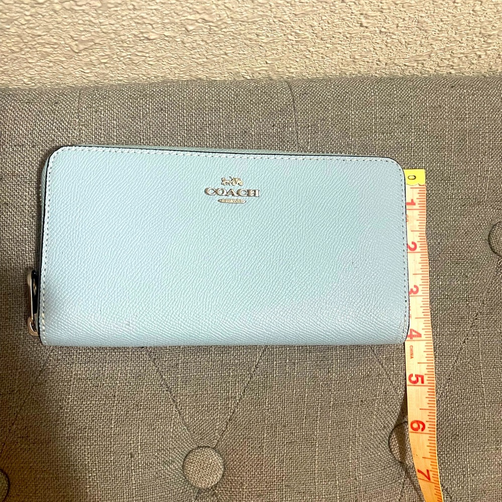 Powder blue Coach wallet with silver accents.